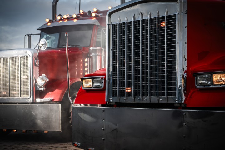 Red semi trucks at dusk