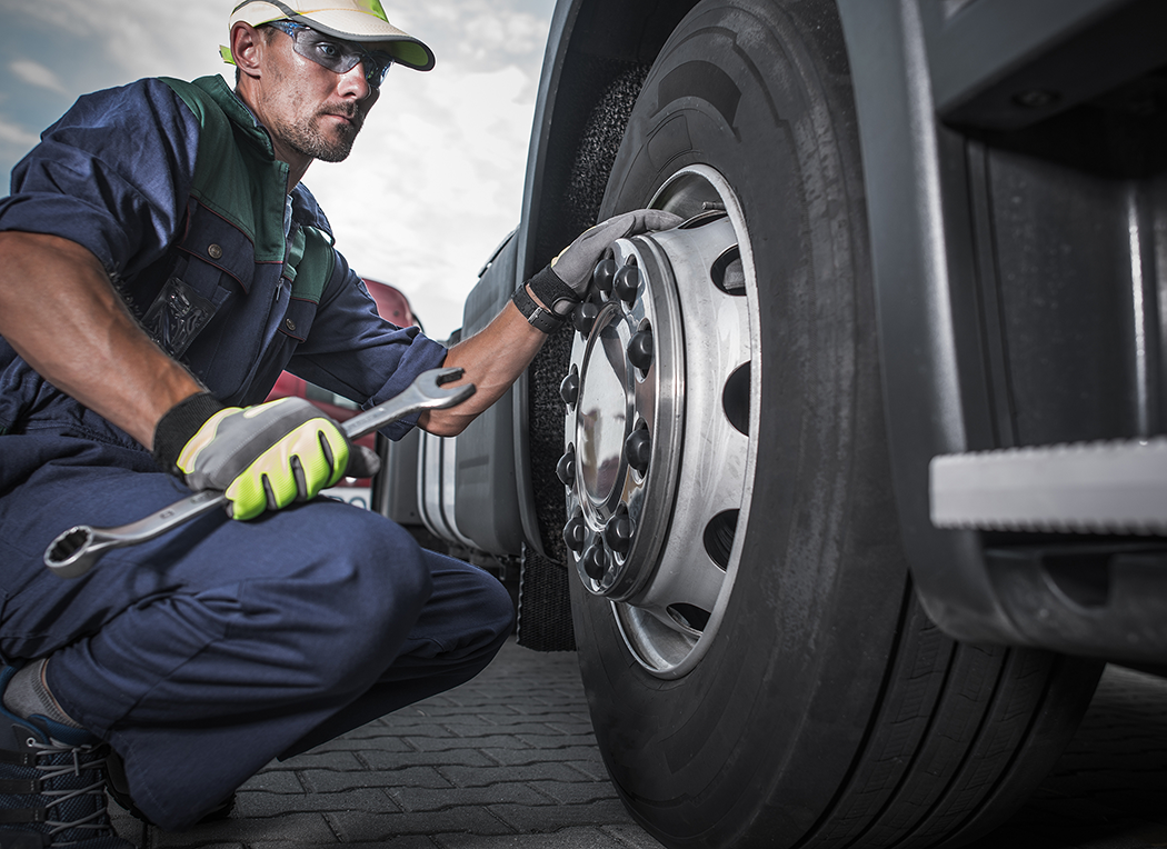 Technician performing minor truck wheel repair